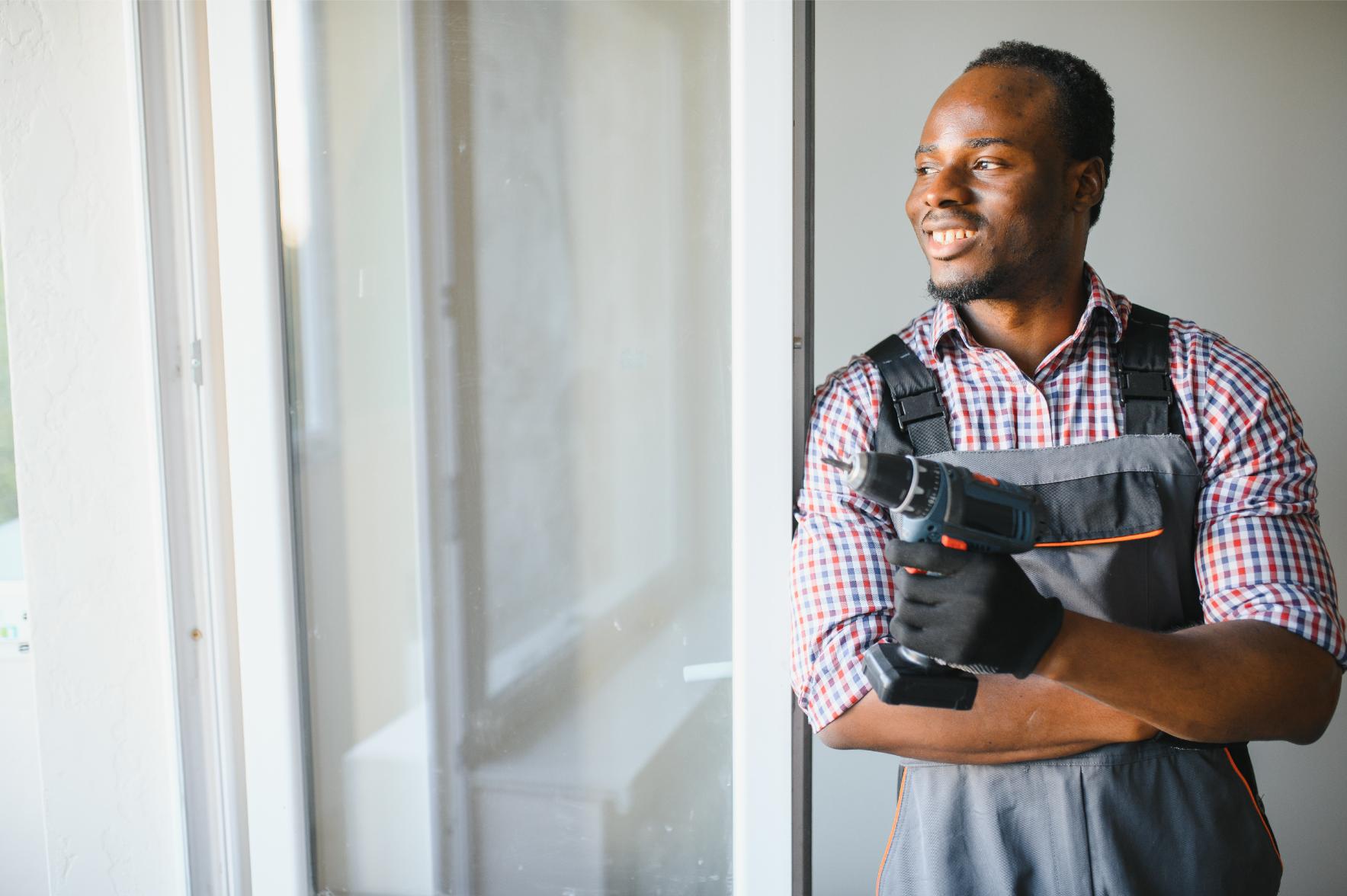 Young African repairman holding a drill Handyman Services
